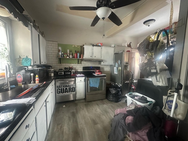 235 Oak St, Marion, OH 43302 - kitchen featuring white cabinetry, hardwood / wood-style flooring, sink, backsplash, and appliances with stainless steel finishes