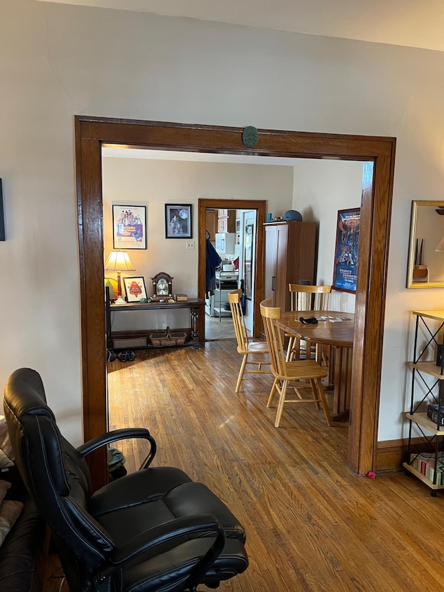 interior space with baseboards and wood finished floors