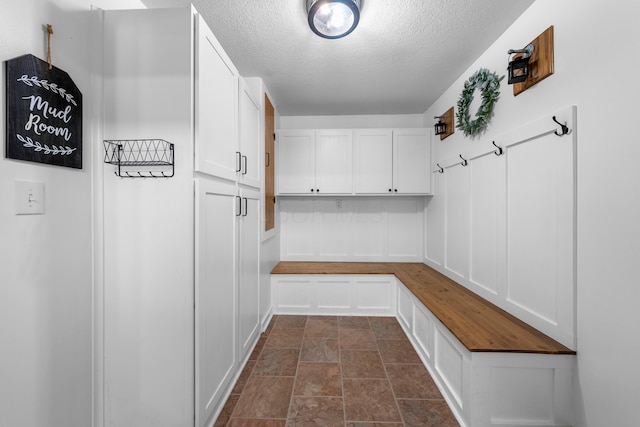 mudroom featuring a textured ceiling