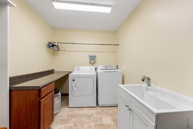 clothes washing area featuring washer and dryer and cabinet space