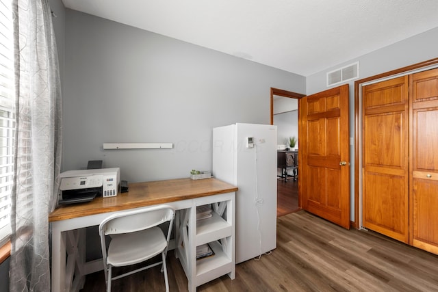 office area with wood finished floors and visible vents