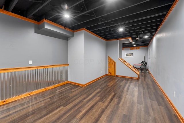 finished basement featuring baseboards and wood finished floors