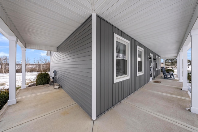 snow covered patio with covered porch