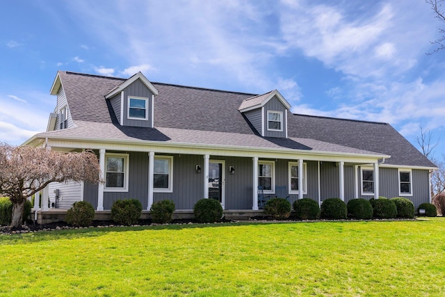 view of front of house with a front lawn, a porch, and roof with shingles