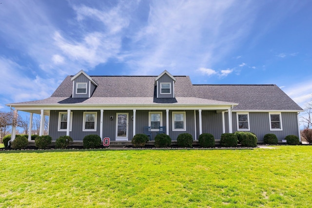 view of front of property featuring a shingled roof, a front lawn, and a porch