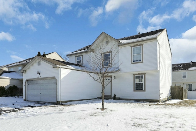 traditional-style house featuring a garage and fence