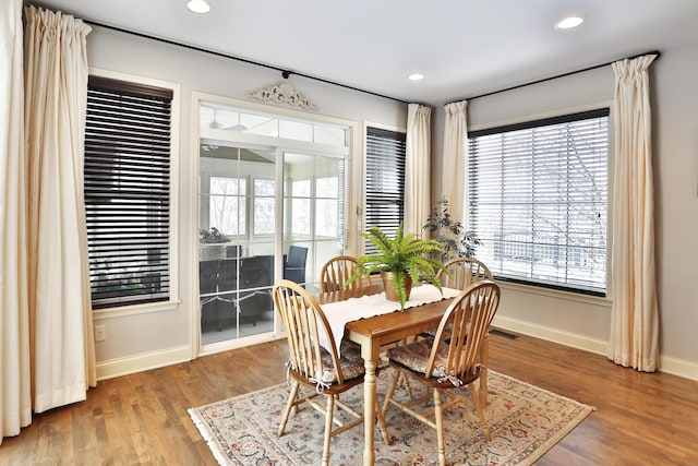 dining space with visible vents, baseboards, wood finished floors, and recessed lighting