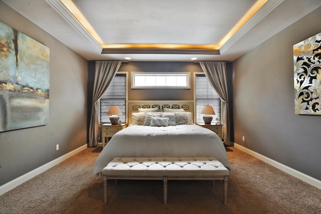 bedroom with a raised ceiling, carpet flooring, and baseboards