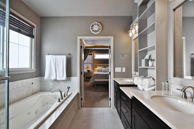 ensuite bathroom with double vanity, tile patterned flooring, ensuite bath, and a sink