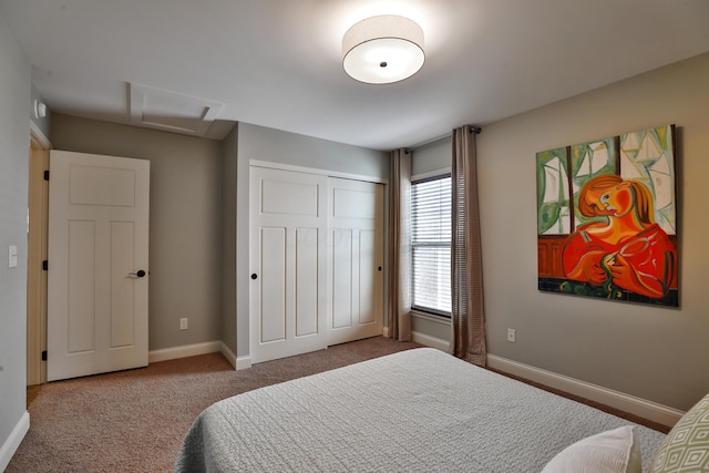 bedroom with a closet, carpet flooring, attic access, and baseboards