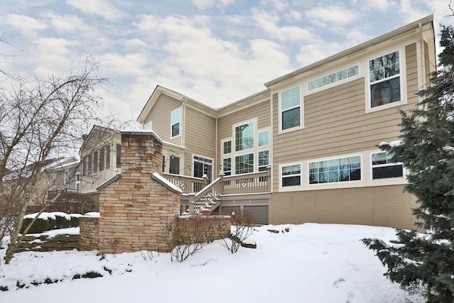 view of snow covered rear of property