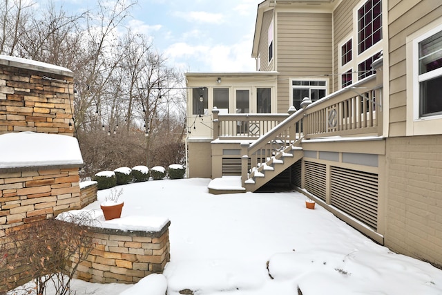 snowy yard featuring stairs