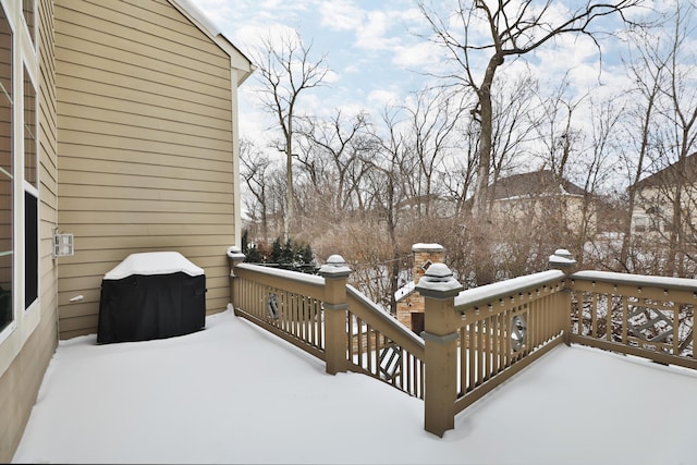 snow covered deck featuring a grill