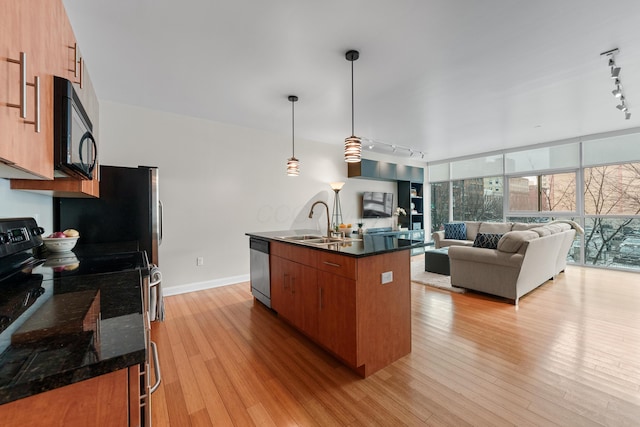 kitchen with black microwave, range with electric stovetop, a sink, dishwasher, and modern cabinets