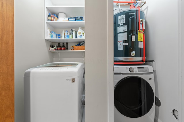 clothes washing area with washer / dryer, laundry area, and electric water heater