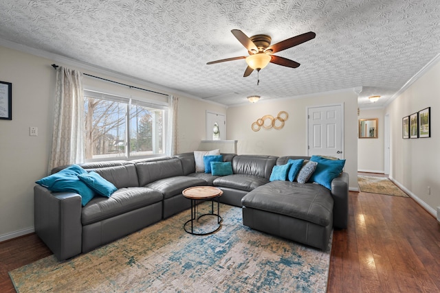 living area featuring dark wood finished floors, ornamental molding, a ceiling fan, a textured ceiling, and baseboards