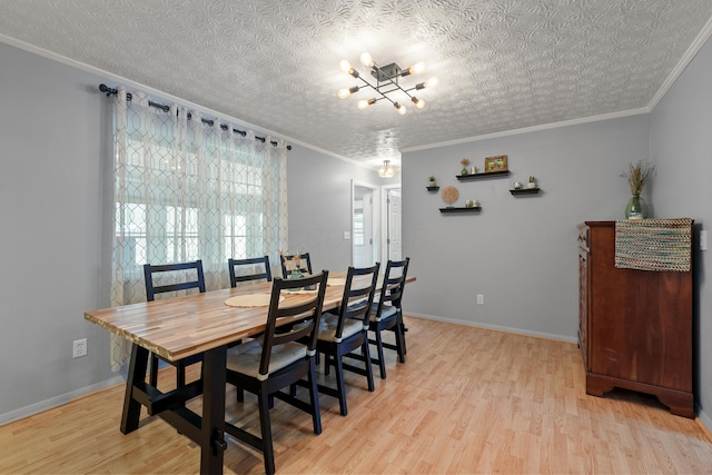 dining room with light wood finished floors, baseboards, ornamental molding, and a textured ceiling