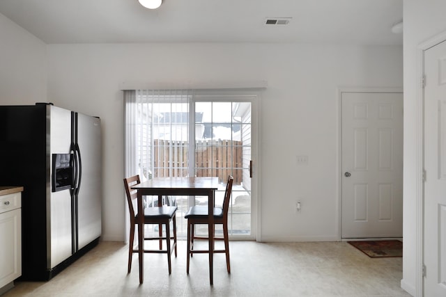 dining room with visible vents and baseboards