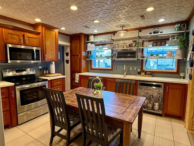 kitchen featuring light countertops, appliances with stainless steel finishes, open shelves, and an ornate ceiling