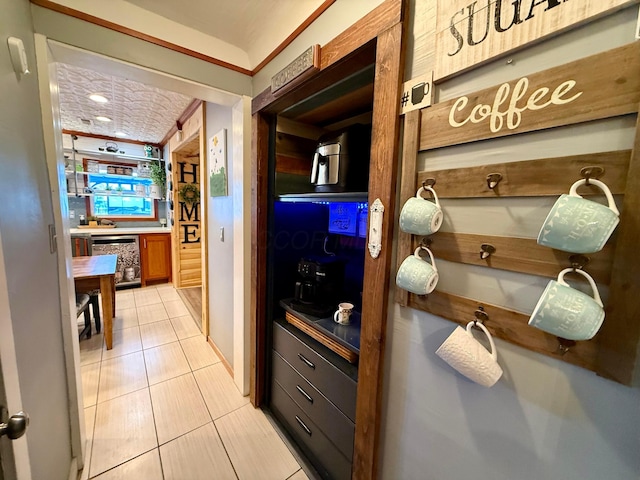 hallway with wine cooler and light tile patterned flooring