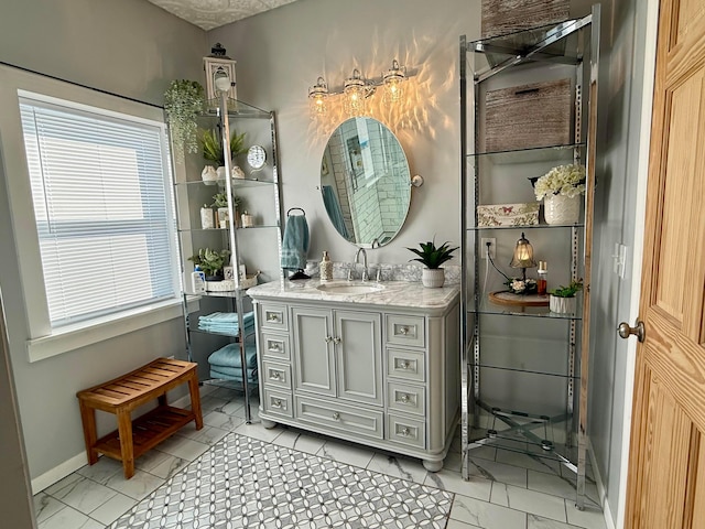 bathroom featuring baseboards and vanity