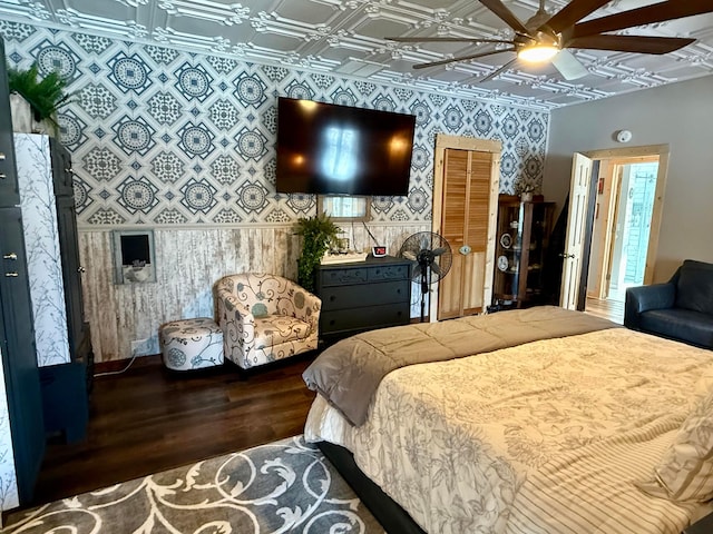 bedroom featuring an ornate ceiling, wood finished floors, ceiling fan, and wallpapered walls