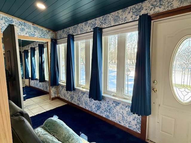 tiled foyer entrance featuring vaulted ceiling, baseboards, wooden ceiling, and wallpapered walls