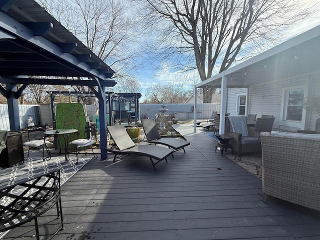 deck featuring outdoor lounge area, a fenced backyard, and a pergola