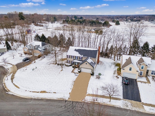 snowy aerial view featuring a residential view