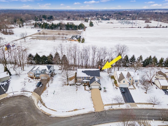 snowy aerial view with a residential view