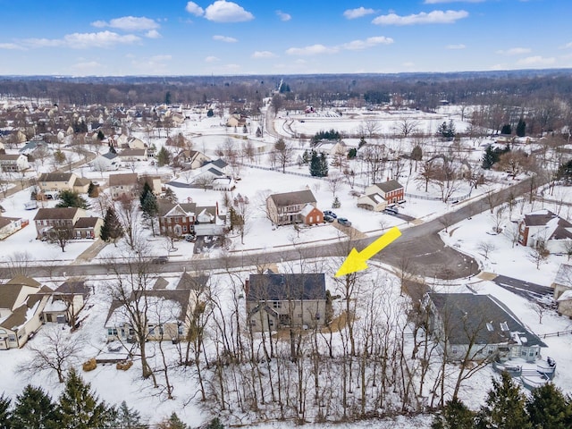 snowy aerial view with a residential view