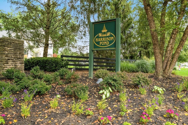 community / neighborhood sign featuring fence