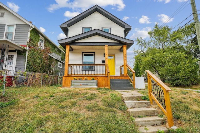 view of front of property featuring covered porch and a front yard