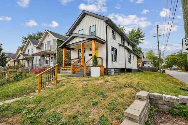 view of front of house featuring covered porch and a front yard