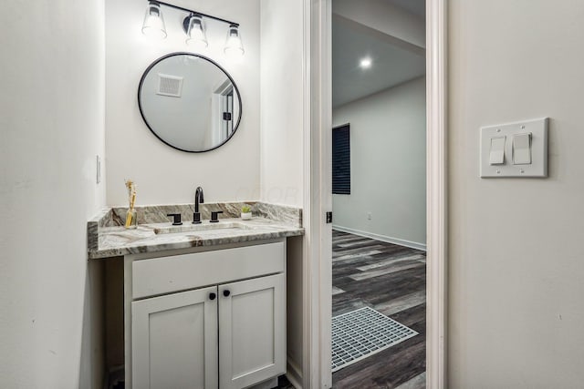 bathroom with vanity and hardwood / wood-style floors