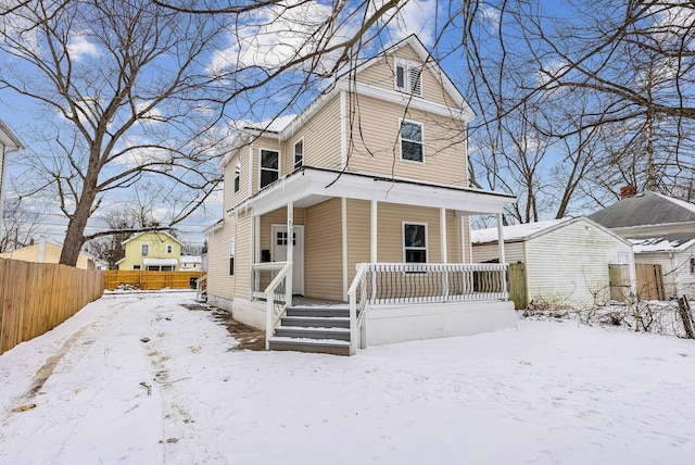 view of front of home with covered porch and fence