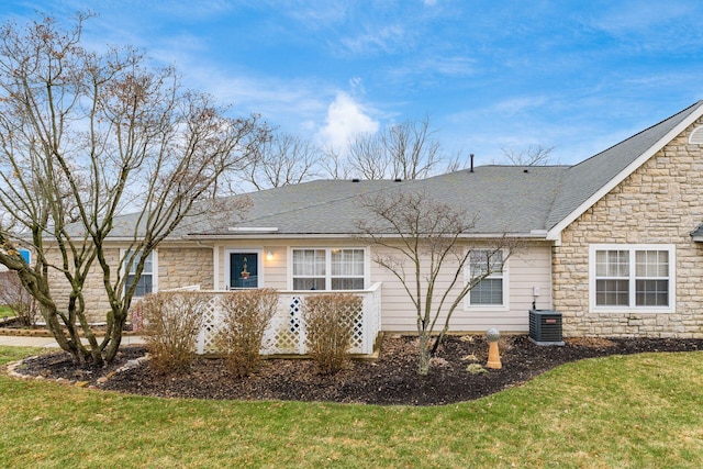 back of house with a yard and central AC unit