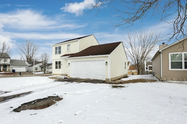 snow covered property featuring a garage