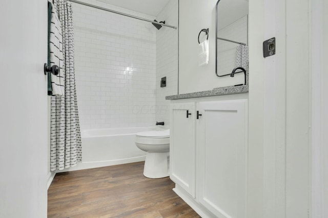 full bath featuring vanity, toilet, shower / tub combo, and wood finished floors