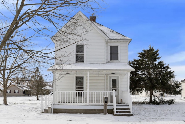 view of front of house featuring a chimney