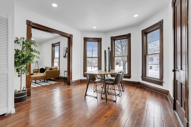 dining area featuring baseboards, dark wood finished floors, and recessed lighting