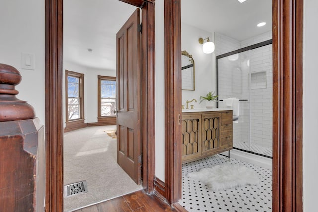 interior space featuring wood finished floors, visible vents, and baseboards