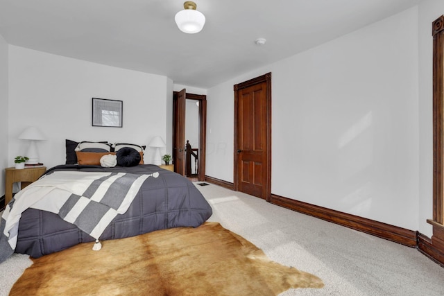 bedroom with carpet flooring and baseboards