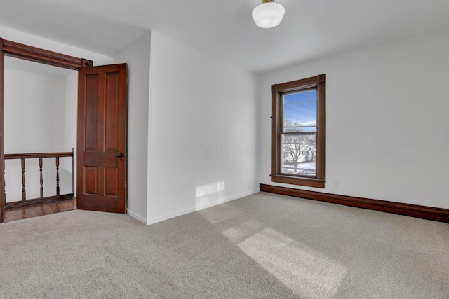 carpeted empty room with visible vents and baseboards