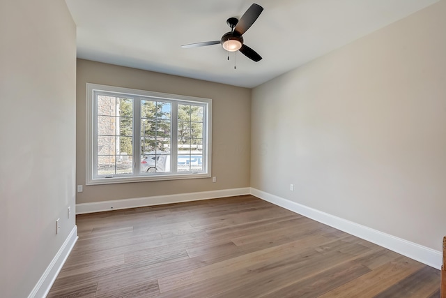 unfurnished room featuring light wood-type flooring, ceiling fan, and baseboards