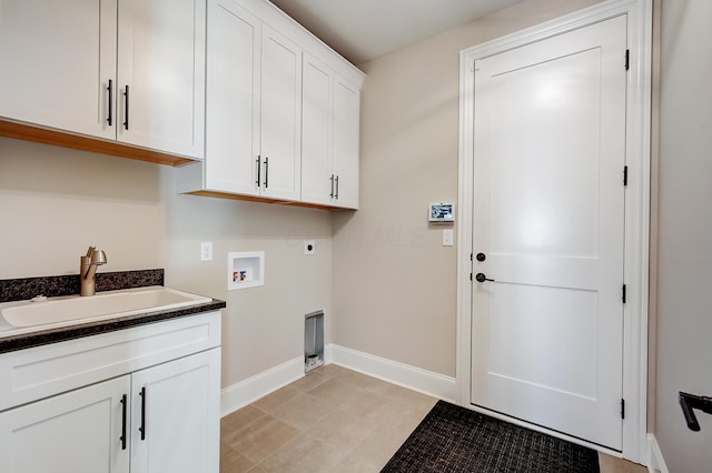 laundry area with hookup for a washing machine, hookup for an electric dryer, a sink, baseboards, and cabinet space