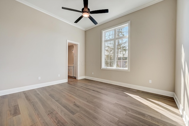 empty room featuring light wood-type flooring, crown molding, baseboards, and ceiling fan