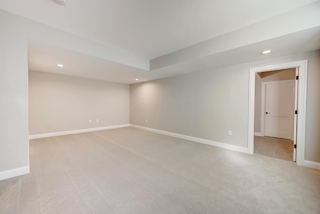 empty room with light carpet, baseboards, and recessed lighting