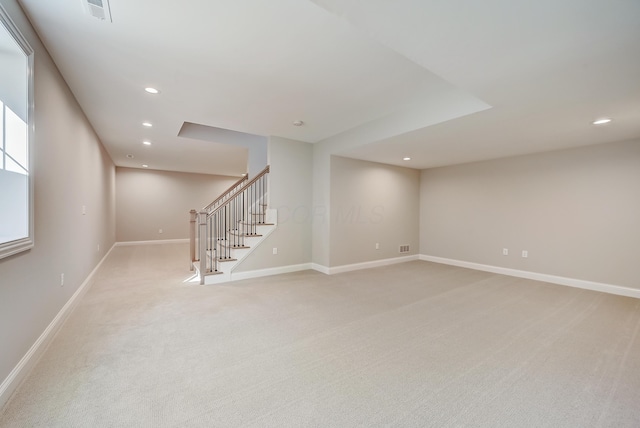 unfurnished room with baseboards, stairway, visible vents, and recessed lighting