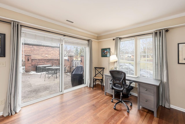 home office featuring ornamental molding, visible vents, and wood finished floors